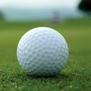 Closeup of a golf ball on the green